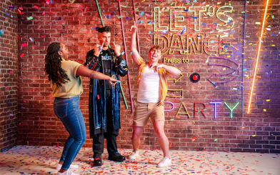 Guests dancing with confetti at Madame Tussauds Orlando party exhibit.