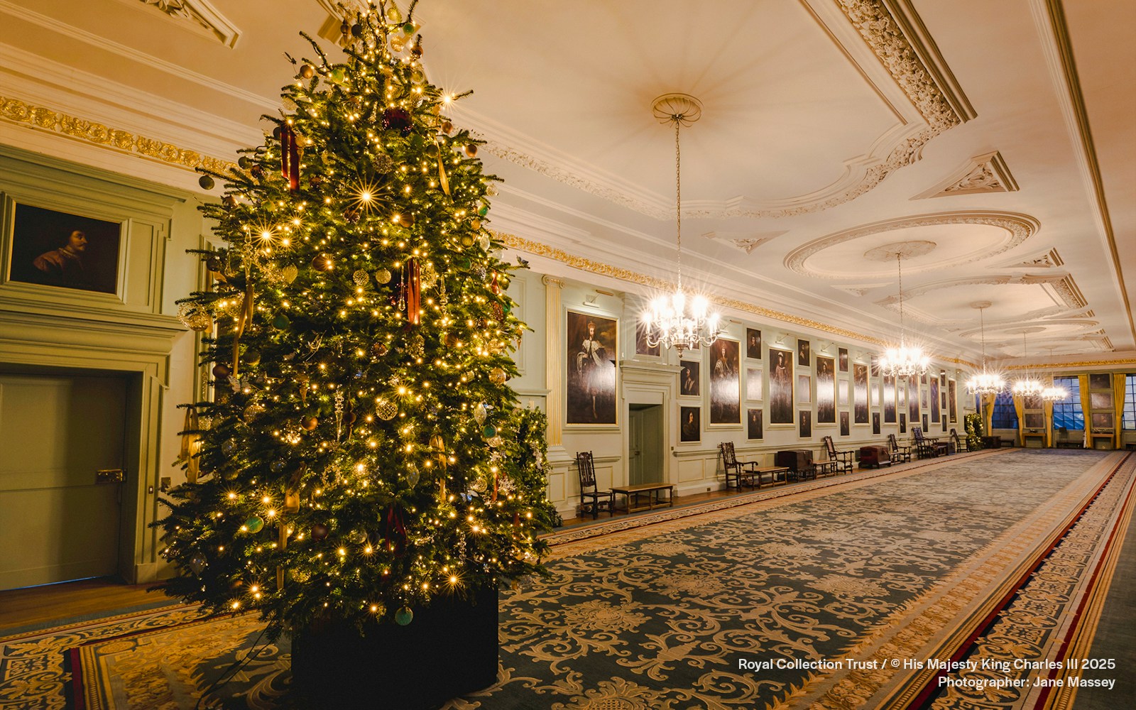 Palace of Holyroodhouse grand hall with Christmas tree and festive decorations.