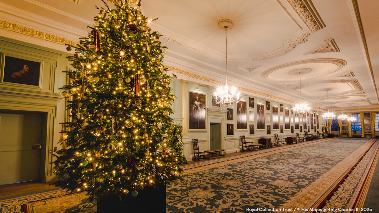 Palace of Holyroodhouse grand hall with Christmas tree and festive decorations.