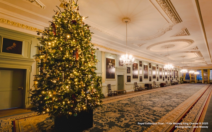 Palace of Holyroodhouse grand hall with Christmas tree and festive decorations.