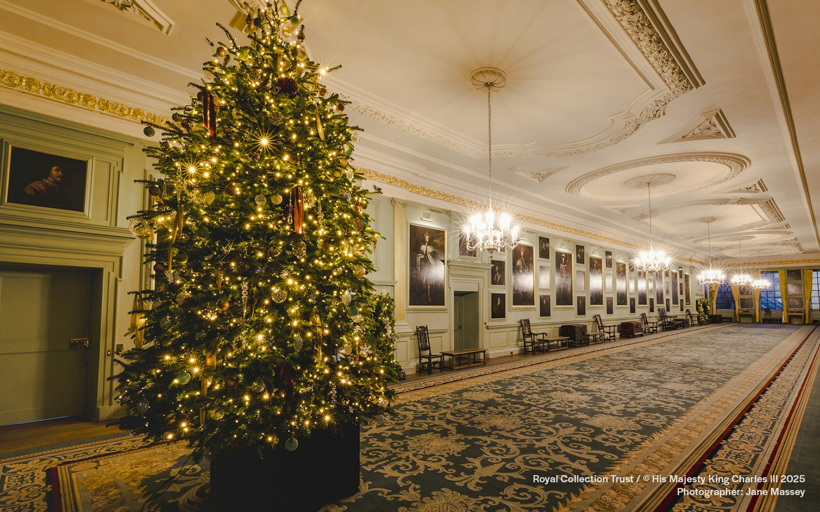 Palace of Holyroodhouse grand hall with Christmas tree and festive decorations.