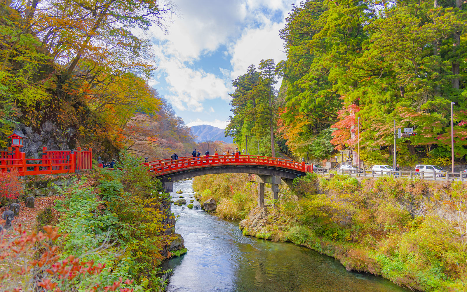 Shinkyo Bridge over a river surrounded by autumn foliage in Nikko, Japan.