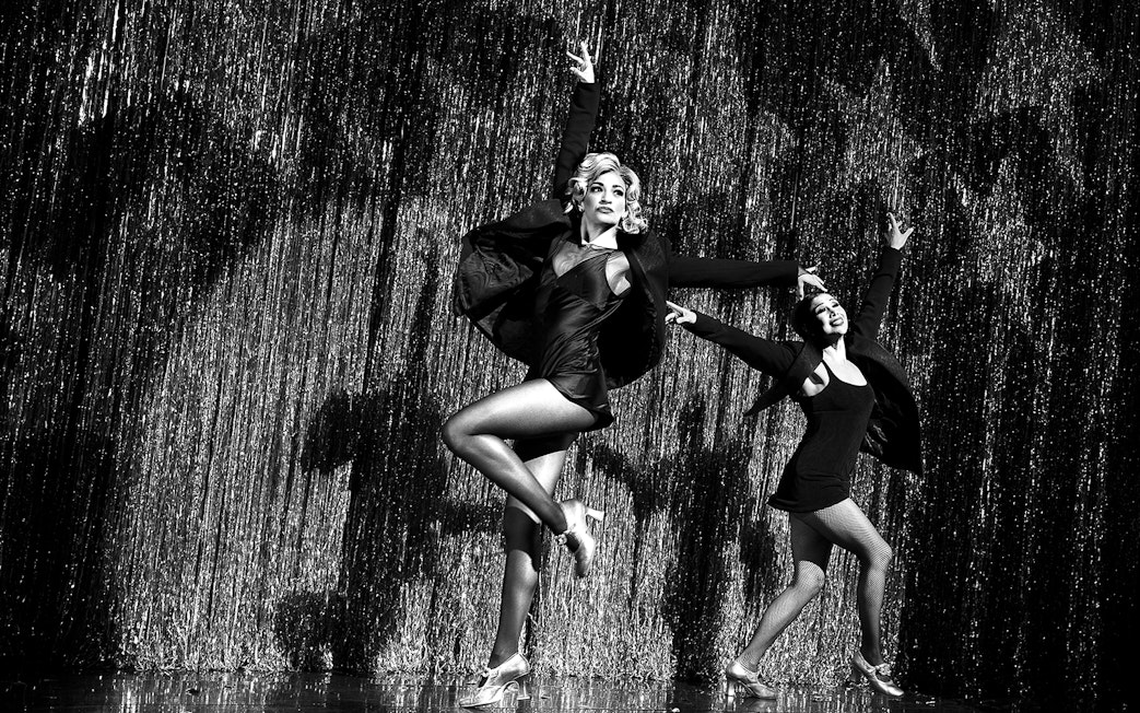 Performers dancing on stage in a Chicago musical show.