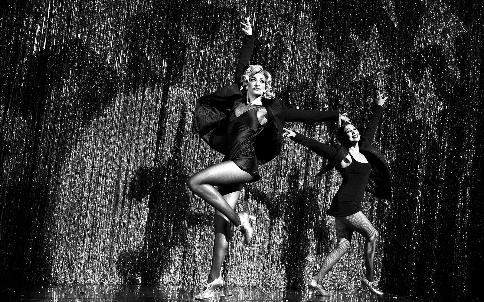 Performers dancing on stage in a Chicago musical show.