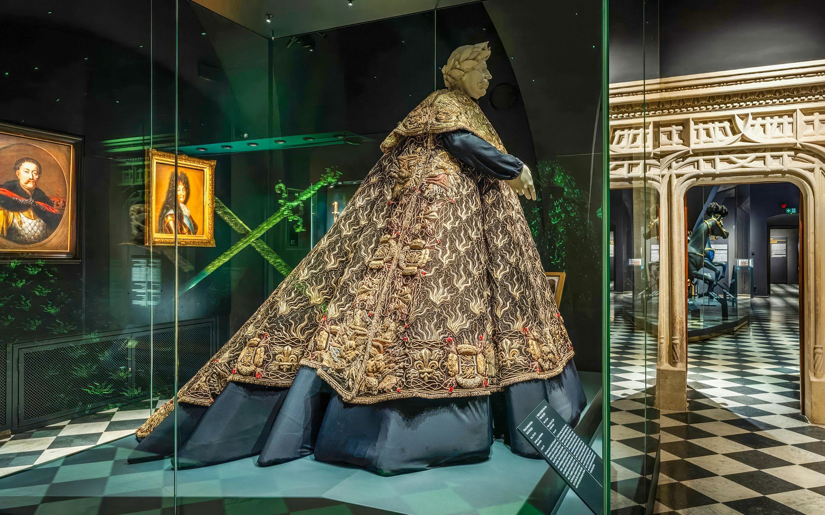 Crown Treasury exhibit with ornate robe and portraits, Wawel Castle, Kraków, Poland.