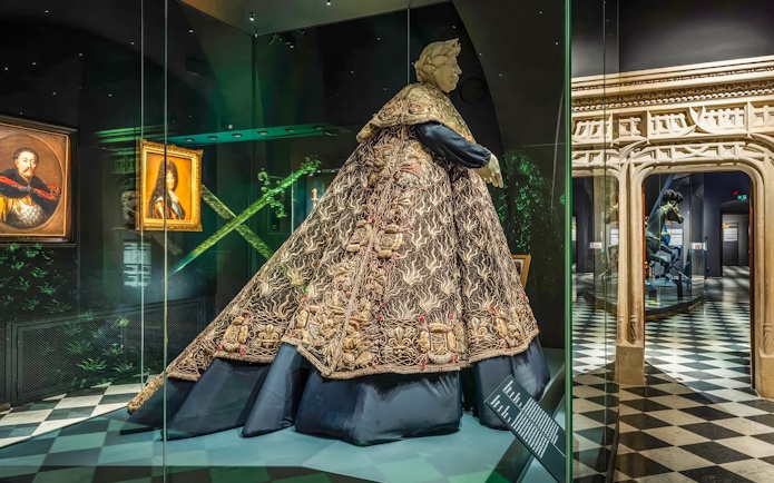 Crown Treasury exhibit with ornate robe and portraits, Wawel Castle, Kraków, Poland.