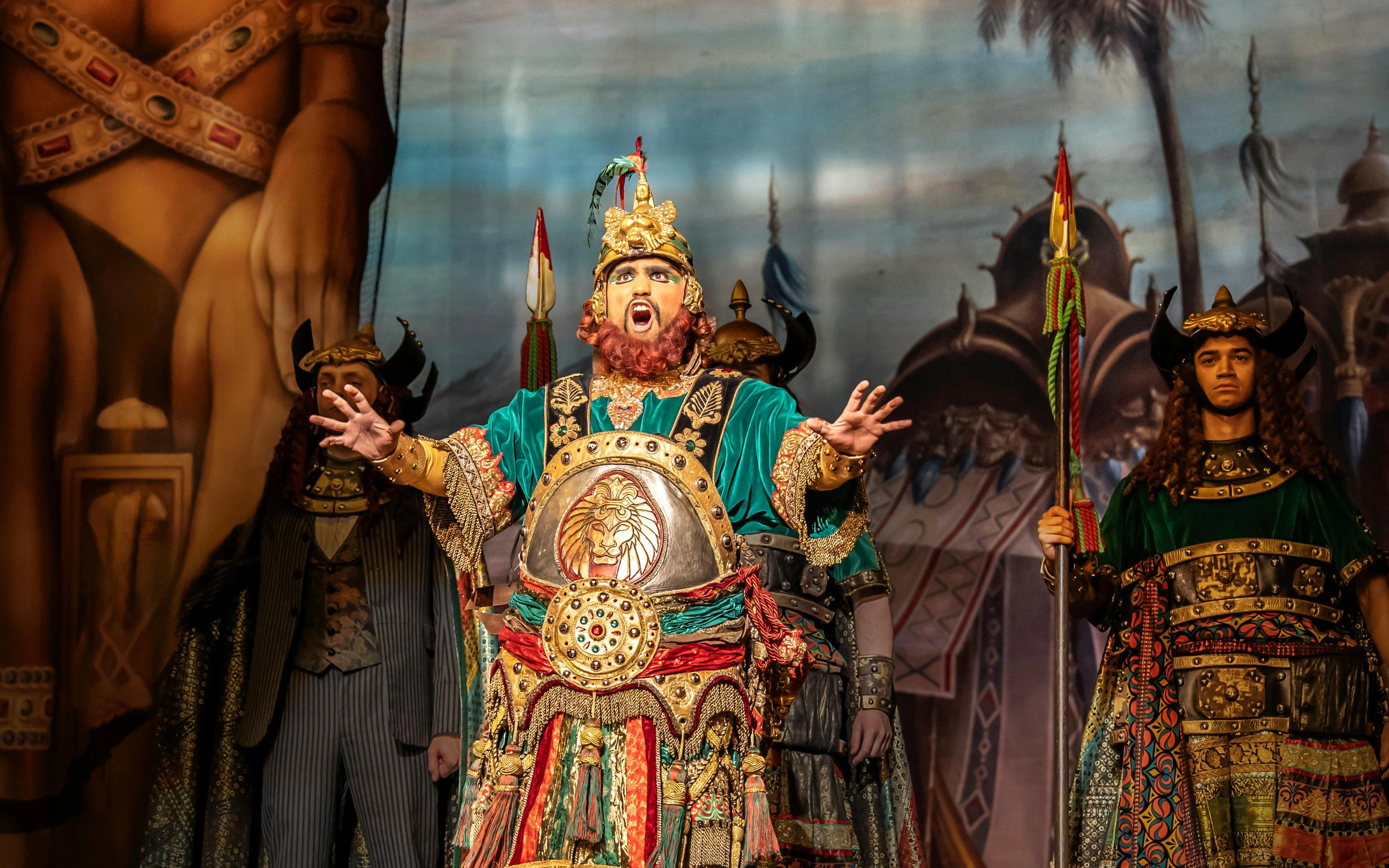 Performer in ornate costume on stage during Phantom production.