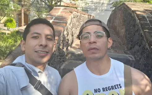 Two people standing on a stone bridge in Mexico City during a self-guided exploration game.
