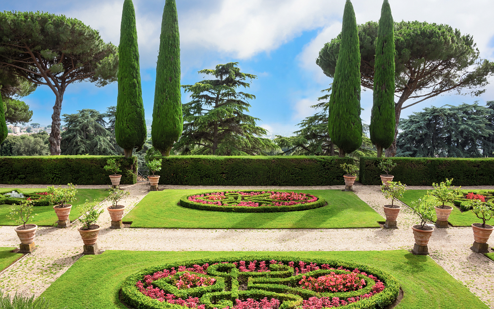 Pontifical Villa Gardens at Castel Gandolfo with manicured lawns and potted plants.