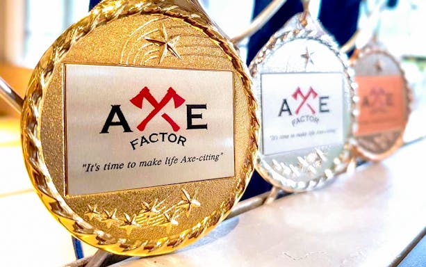 Axe Factor medals displayed in Sentosa, featuring the slogan "It's time to make life Axe-citing.