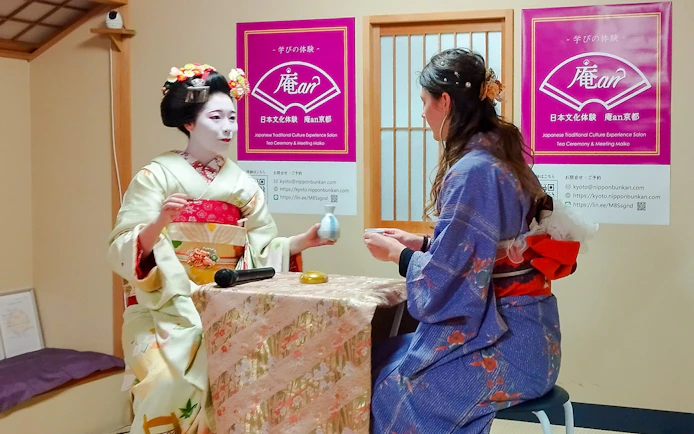 Maiko conducting a matcha tea ceremony with a guest in Kyoto.