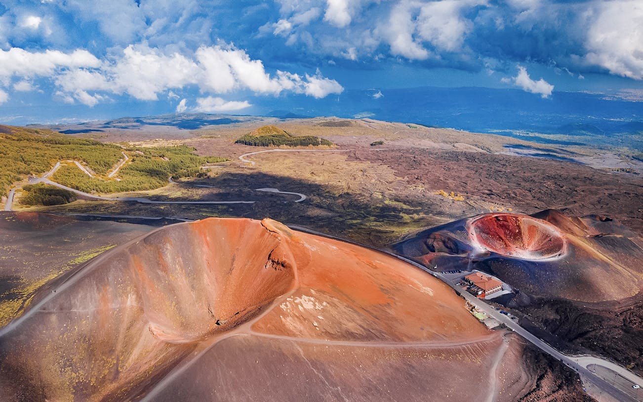 Aerial view of Mount Etna's volcanic craters and surrounding landscape, Sicily, Italy.