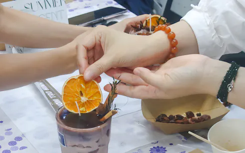 Creating a personalized candle with dried orange slices in Hanoi.