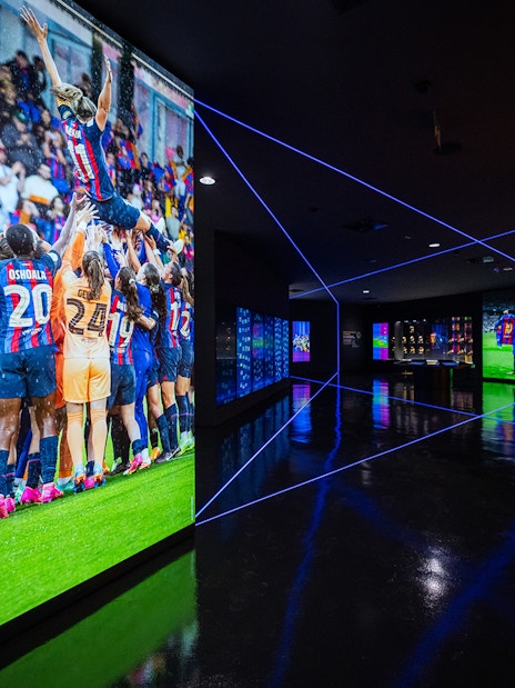 FC Barcelona museum exhibit with team celebration photo and illuminated displays.