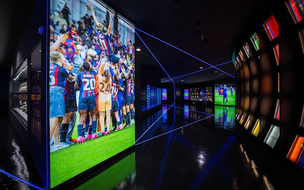 FC Barcelona museum exhibit with team celebration photo and illuminated displays.