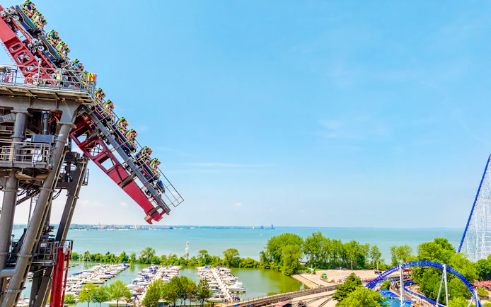 Roller coaster descending at Cedar Point with Lake Erie in the background.