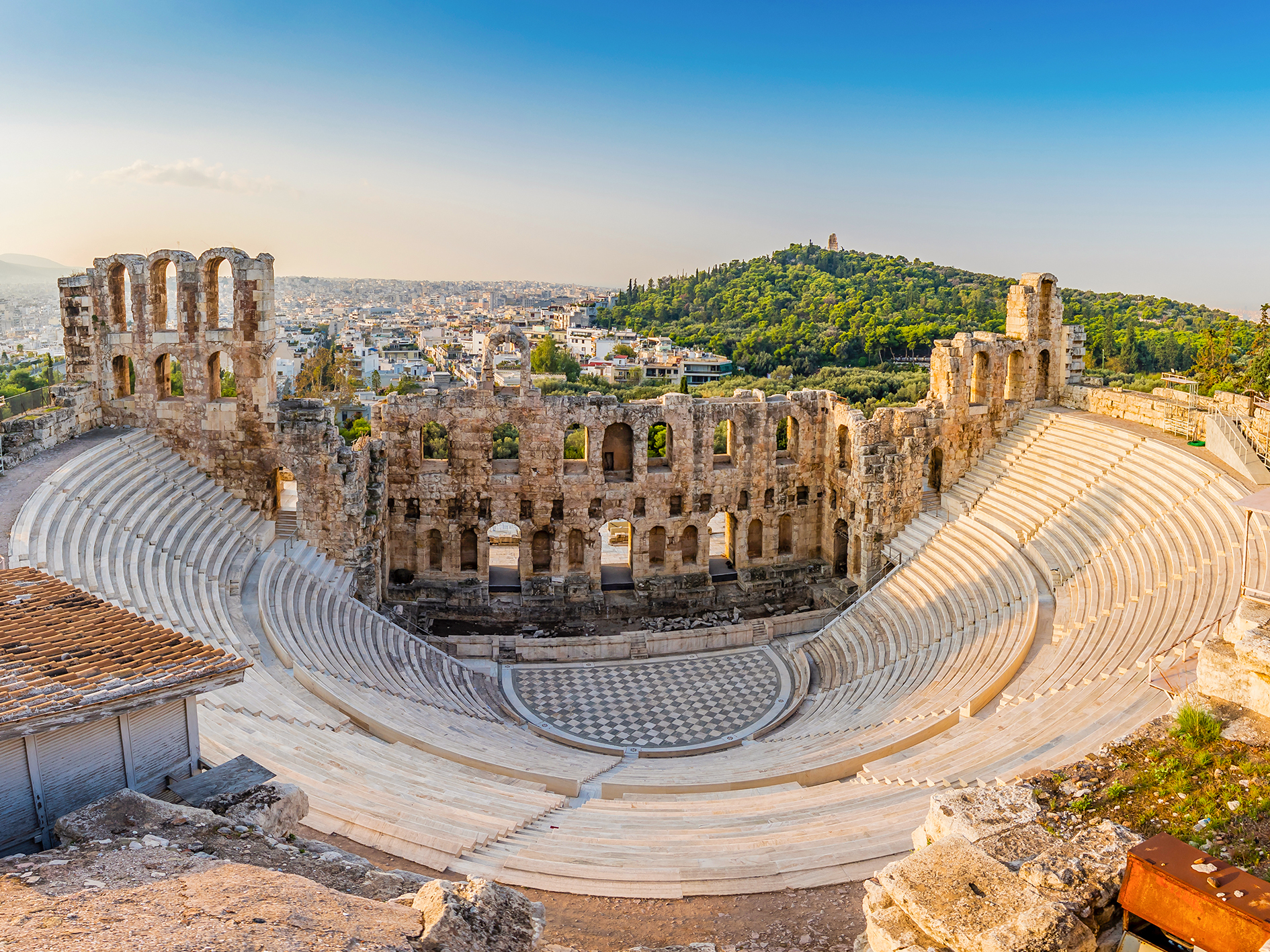 Odeon of Herodes Atticus amphitheater in Athens, Greece, with ancient stone seating and stage.