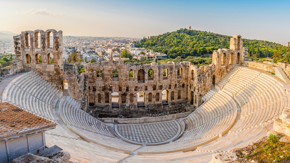 Odeon of Herodes Atticus amphitheater in Athens, Greece, with ancient stone seating and stage.