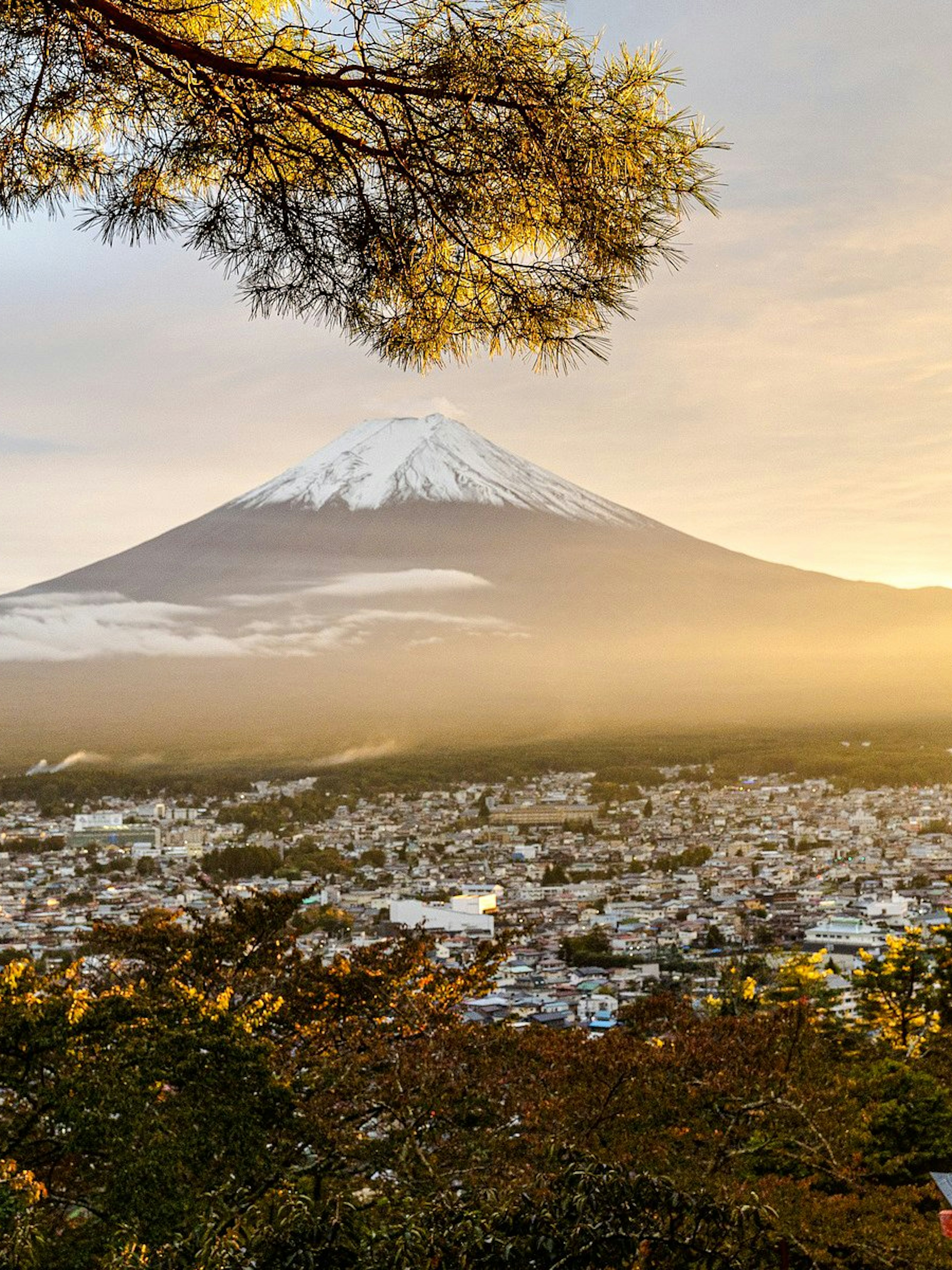 Pagoda overlooking Mount Fuji at sunrise in Japan.