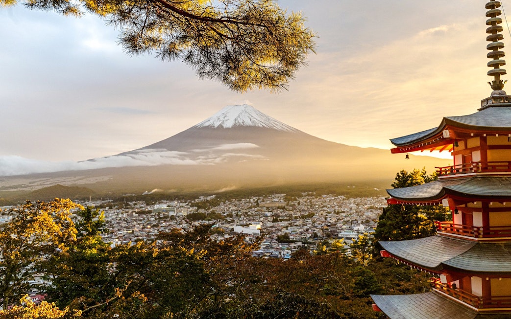 Pagoda overlooking Mount Fuji at sunrise in Japan.