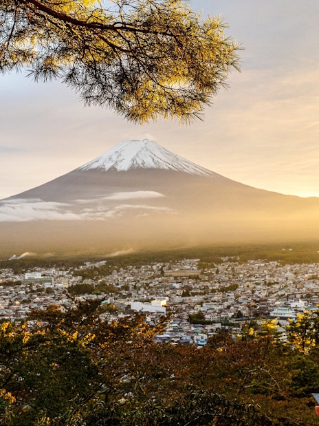 Pagoda overlooking Mount Fuji at sunrise in Japan.