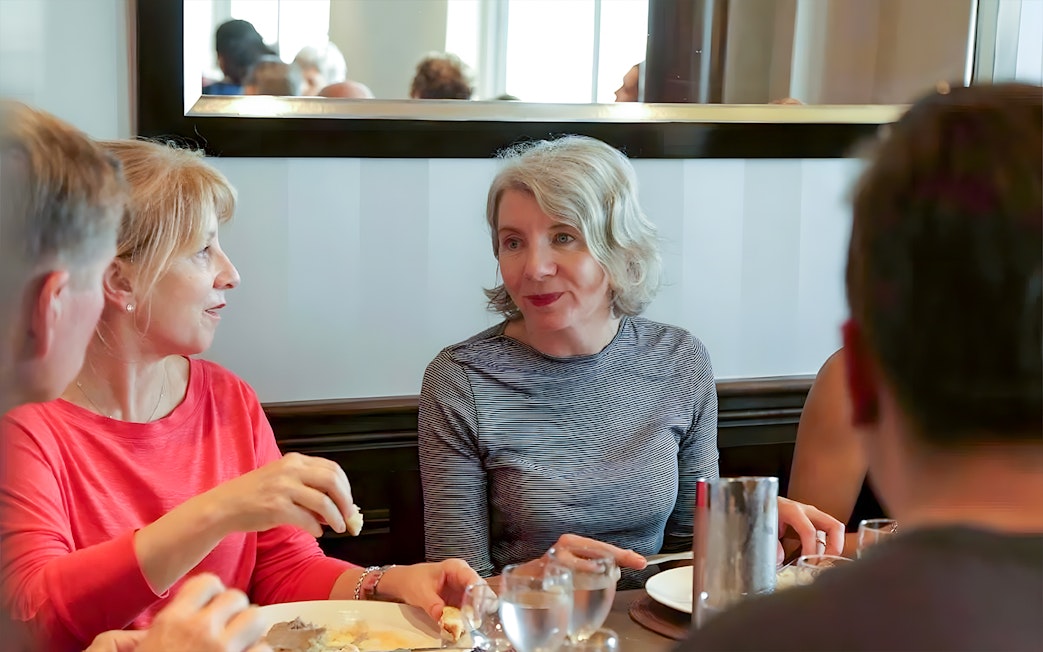 Group dining during D-Day Normandy Beaches tour from Paris.