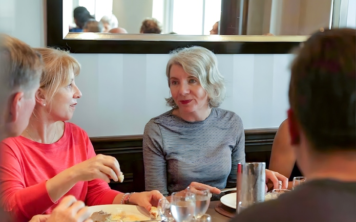 Group dining during D-Day Normandy Beaches tour from Paris.