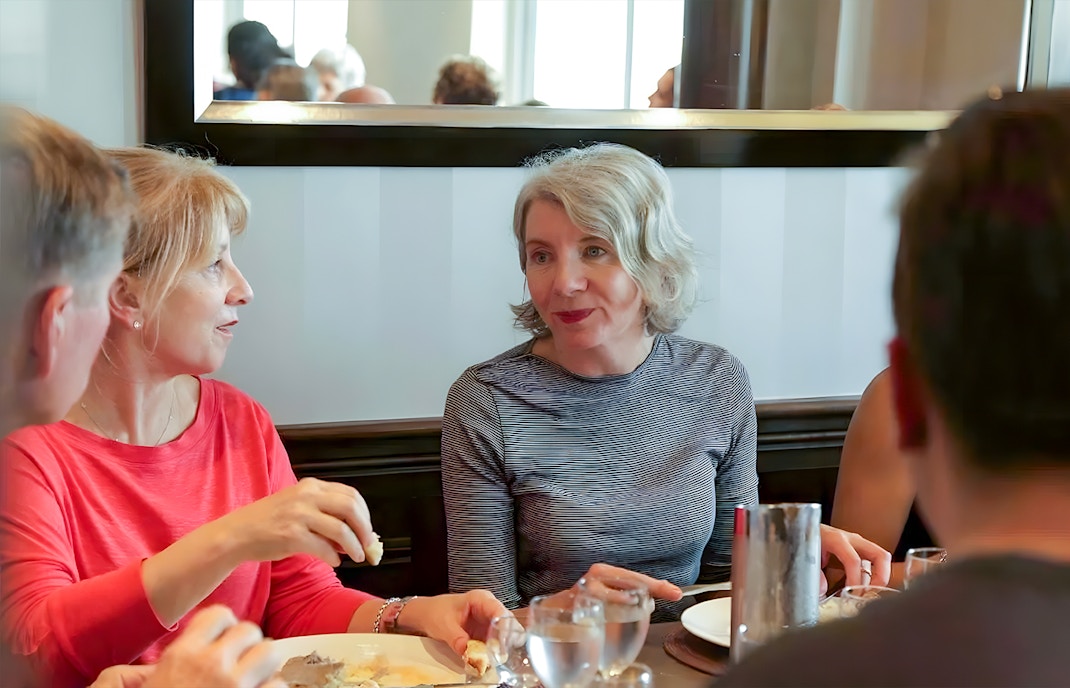 Group dining during D-Day Normandy Beaches tour from Paris.