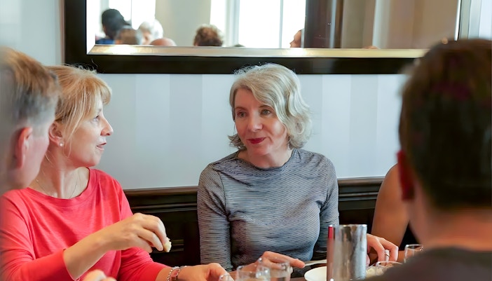 Group dining during D-Day Normandy Beaches tour from Paris.