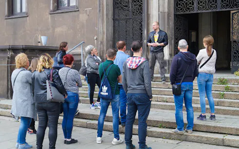 Tour group at Nowa Huta Steel Mill Administration Buildings with guide.