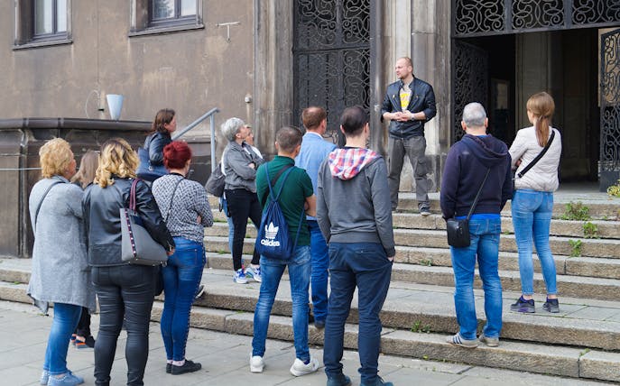 Tour group at Nowa Huta Steel Mill Administration Buildings with guide.