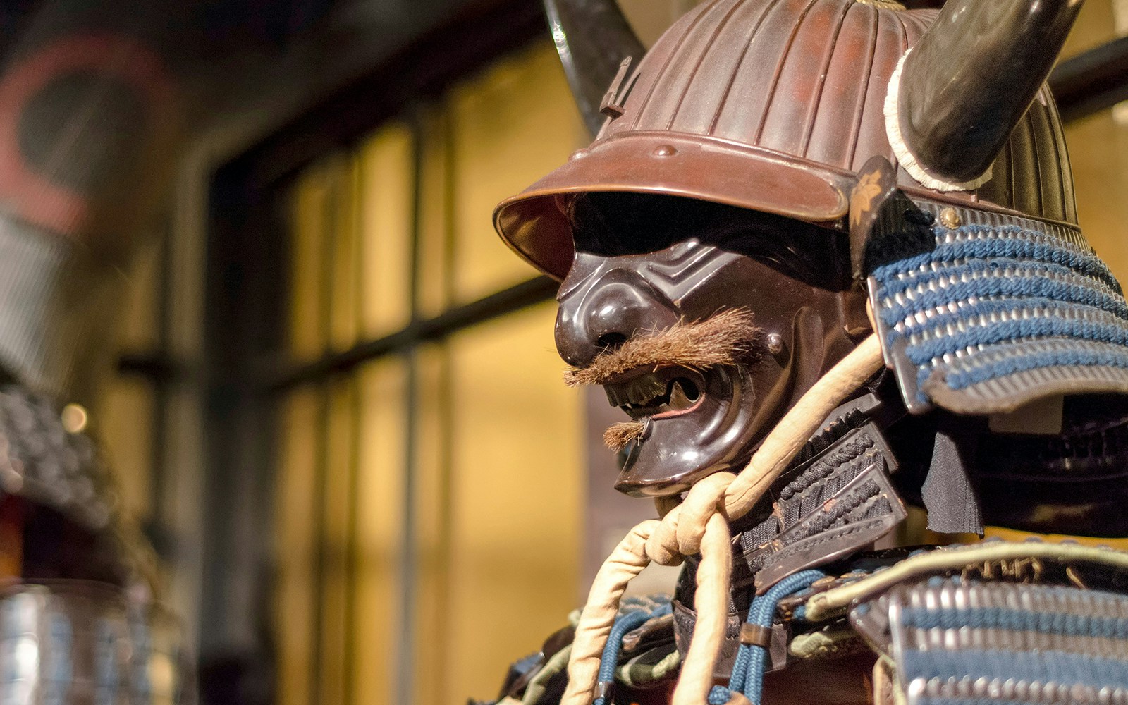 Japanese samurai armor on display in a museum exhibit in Japan.