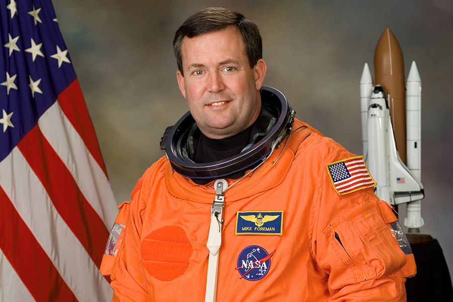 Astronaut Mike Foreman in space suit with NASA logo, Houston Space Center, USA.