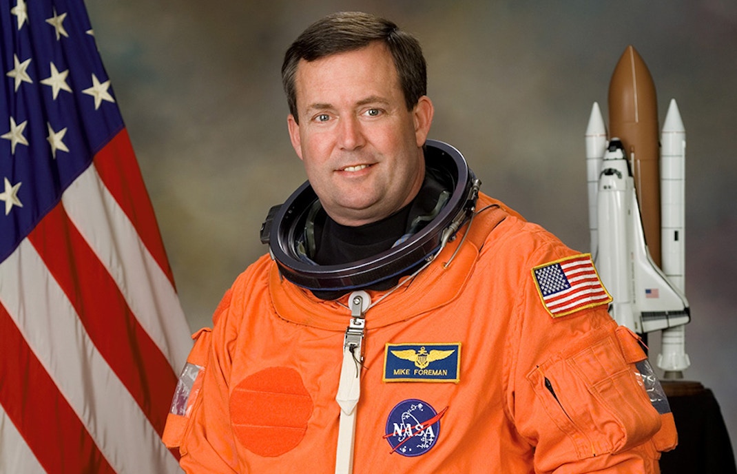 Astronaut Mike Foreman in space suit with NASA logo, Houston Space Center, USA.
