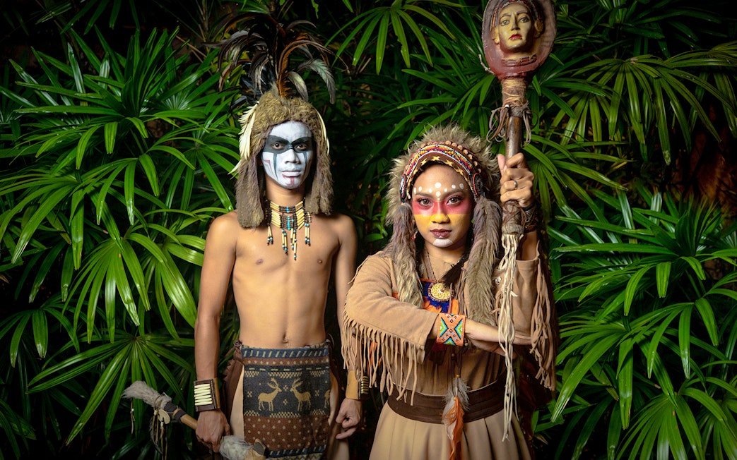Performers in traditional costumes at Sunway Lagoon night park.