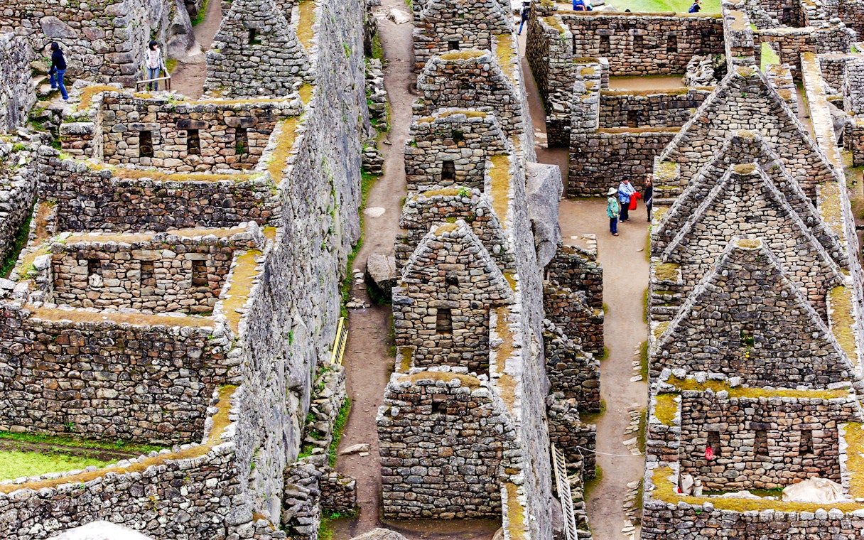 Inca stone houses and pathways at Machu Picchu, Peru.