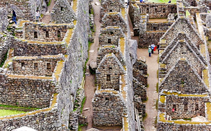 Inca stone houses and pathways at Machu Picchu, Peru.
