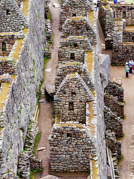 Inca stone houses and pathways at Machu Picchu, Peru.