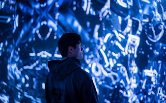 Visitor observing digital art installation in Engine Room, Mercer Labs Museum of Art.