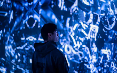 Visitor observing digital art installation in Engine Room, Mercer Labs Museum of Art.