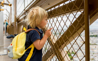 Child viewing Paris from Eiffel Tower Summit.