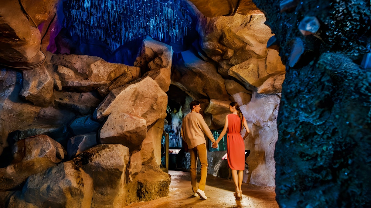Couple exploring cave at Night Safari, Mandai Wildlife Reserve.