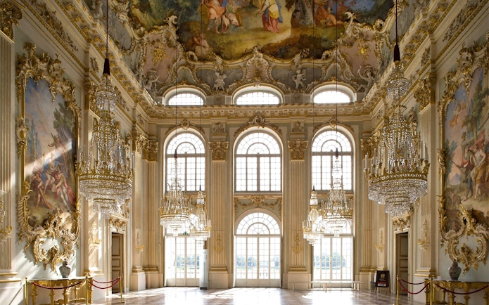 Munich Residenz ornate hall with chandeliers and frescoed ceiling, part of city pass tour.