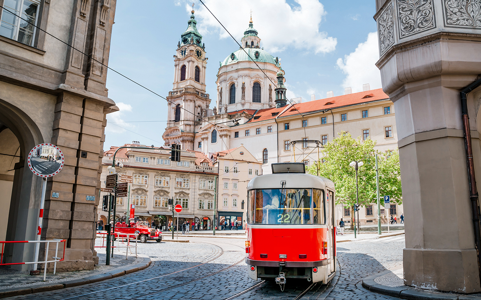 Tram passing near St. Nicholas Church in Prague during a guided tour.
