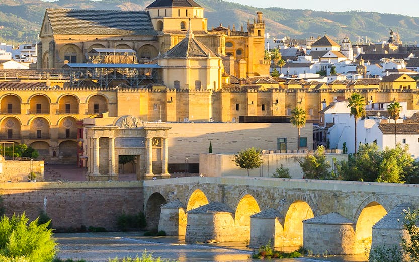 Cathedral and Roman bridge over the Guadalquivir River in Córdoba, Spain.