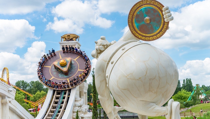 Visitors enjoying the Hydrolix ride at Parc Asterix, France, with vibrant themed surroundings.