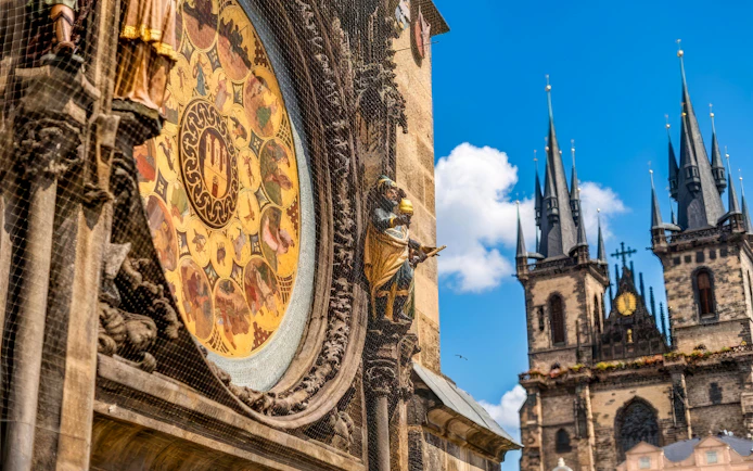Prague Astronomical Clock with Týn Church spires in the background.