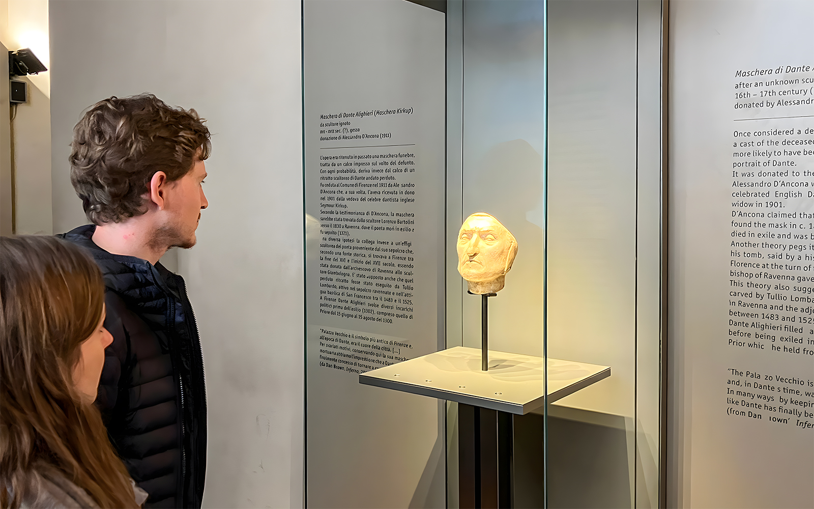Tourists viewing Dante's death mask exhibit at Palazzo Vecchio, Florence.