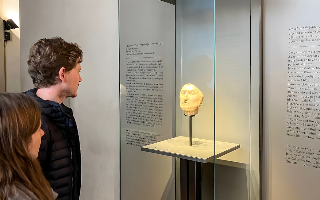 Tourists viewing Dante's death mask exhibit at Palazzo Vecchio, Florence.