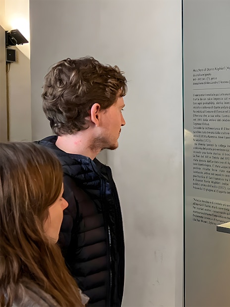 Tourists viewing Dante's death mask exhibit at Palazzo Vecchio, Florence.